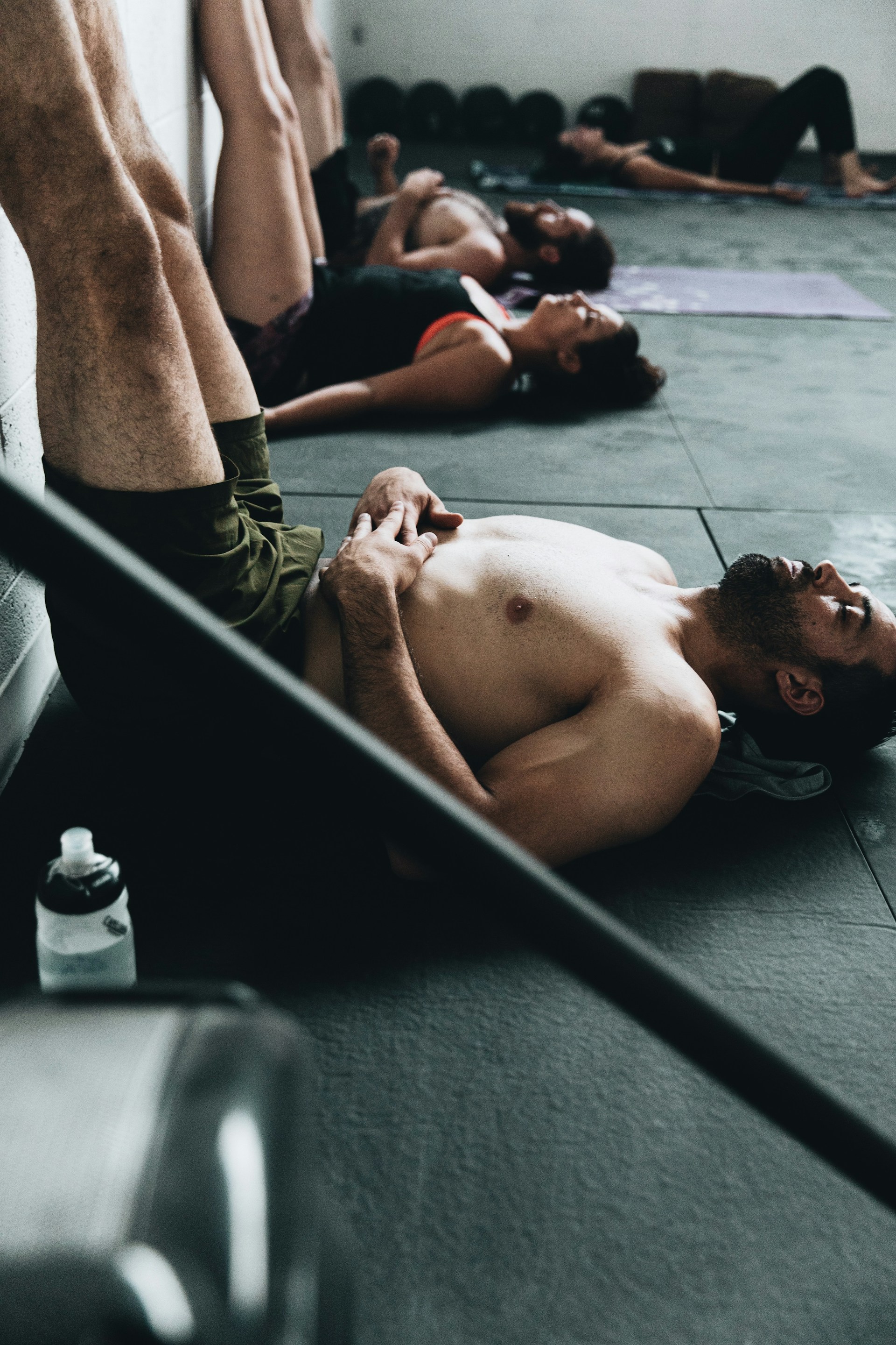man legs up the wall pic in pilates or gym class wearing shorts