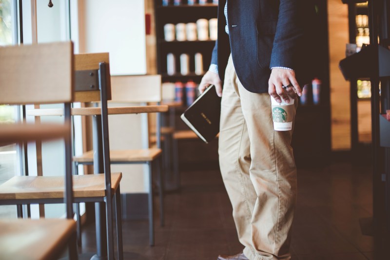 Man in khakis with coffee