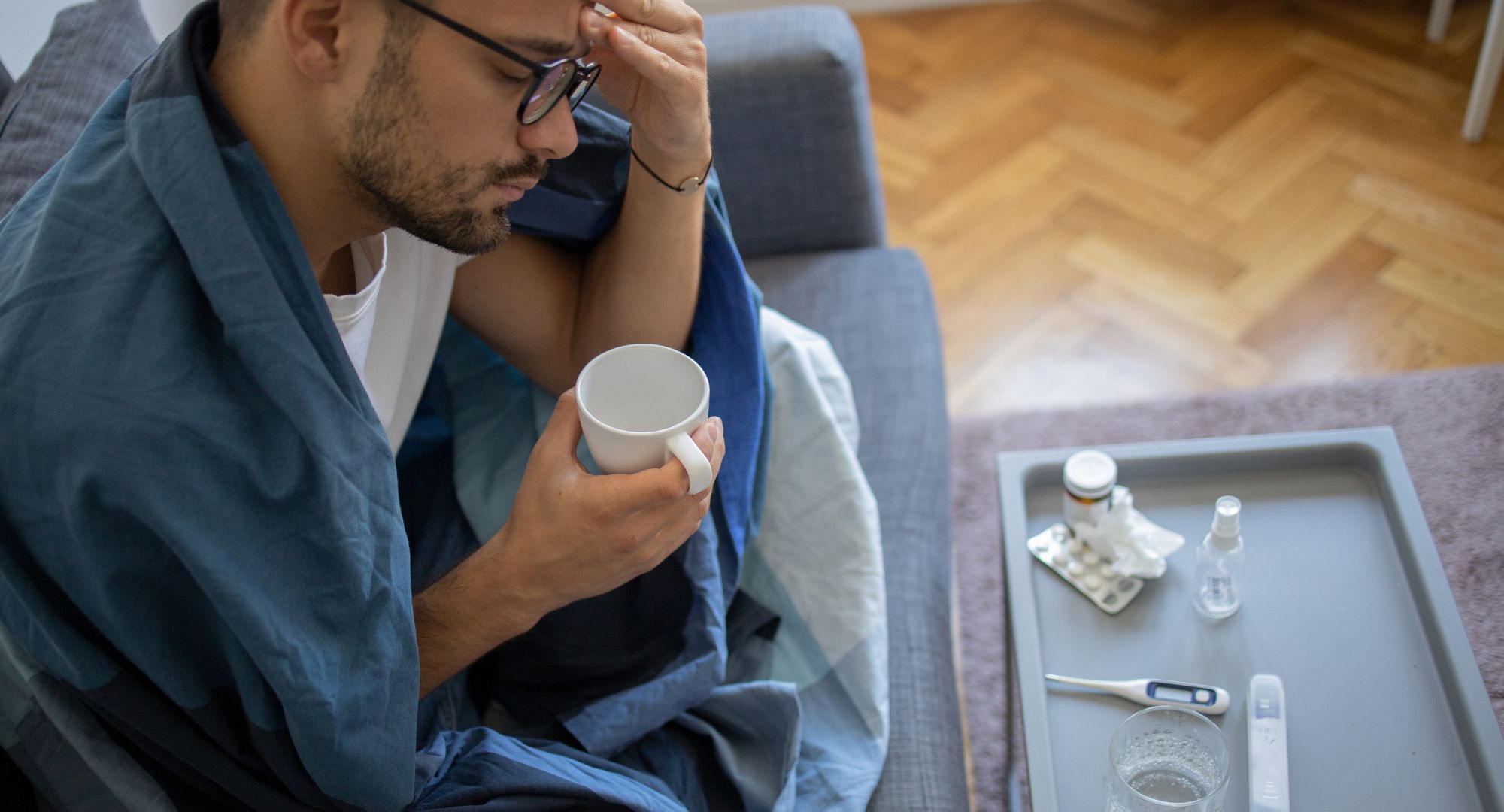 Man hunched over with a cold 