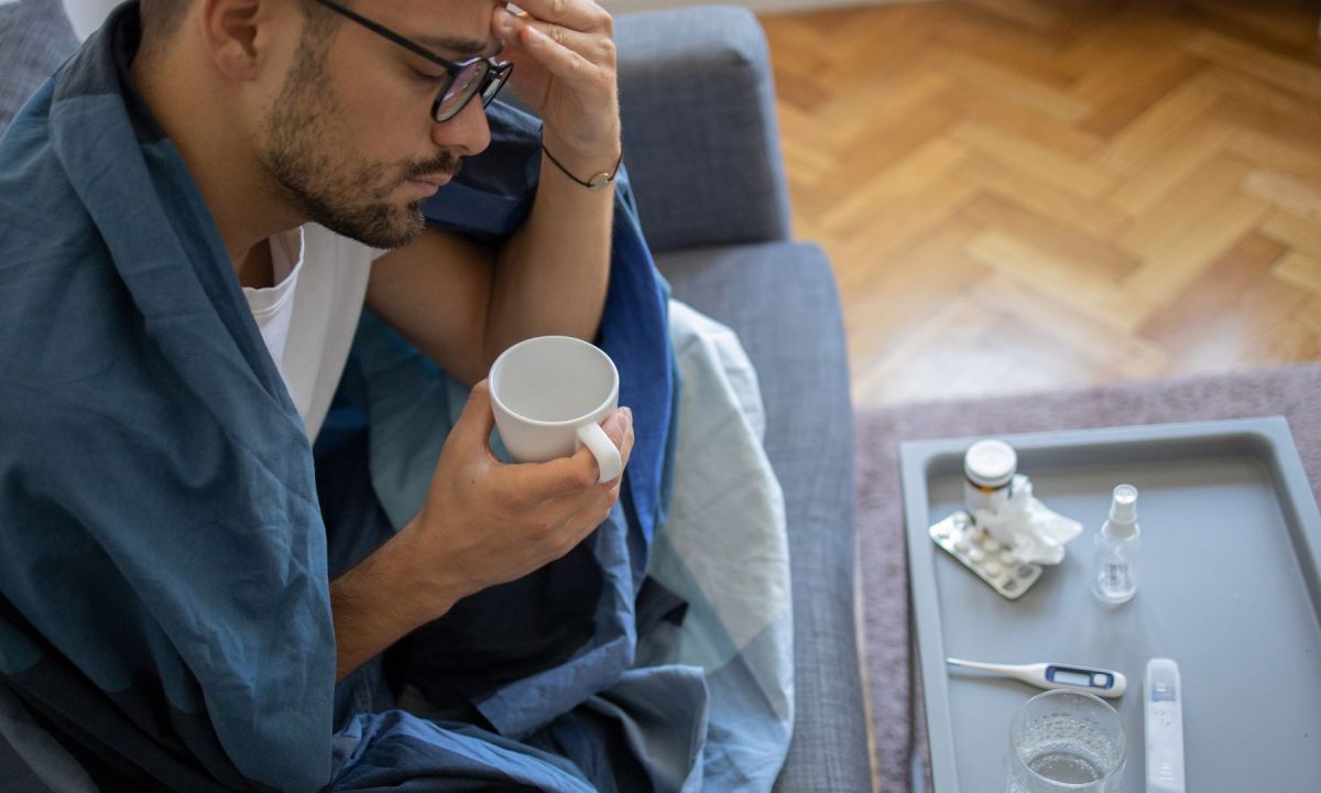 Man hunched over with a cold
