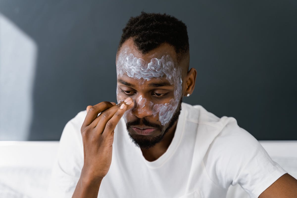 man applying skin cream