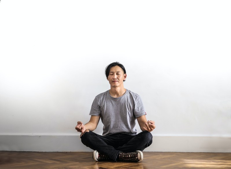 Man sitting on floor cross legged