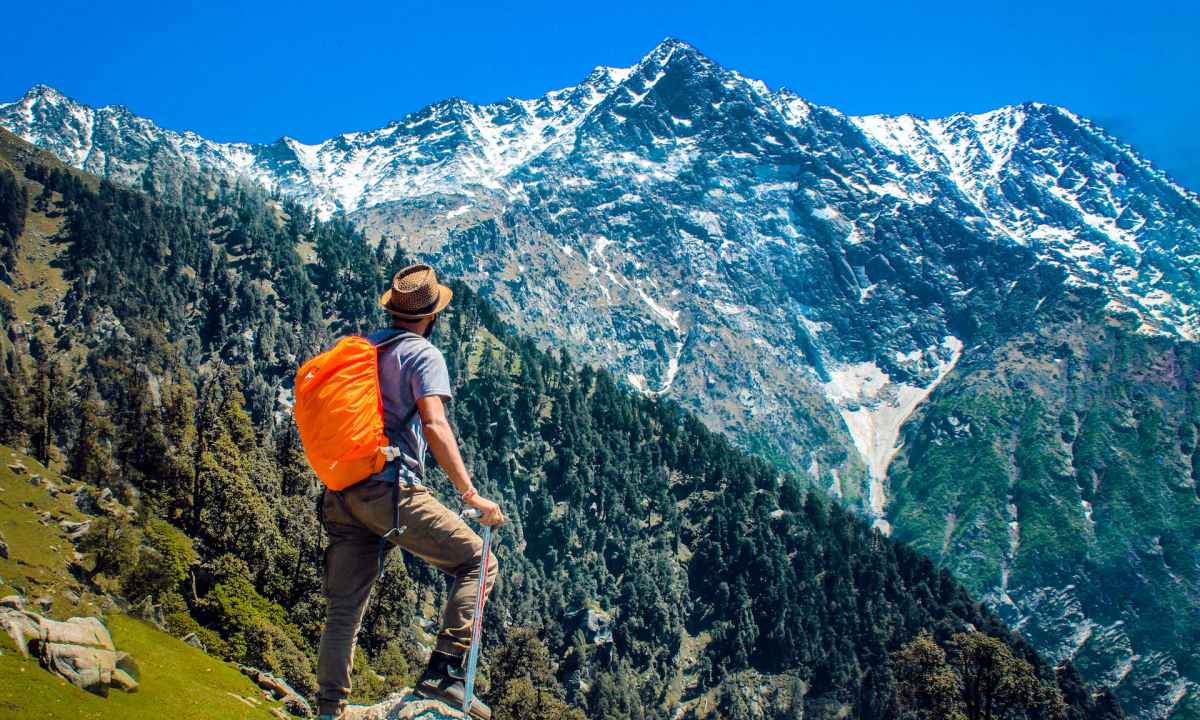 A man hiking to a mountain top