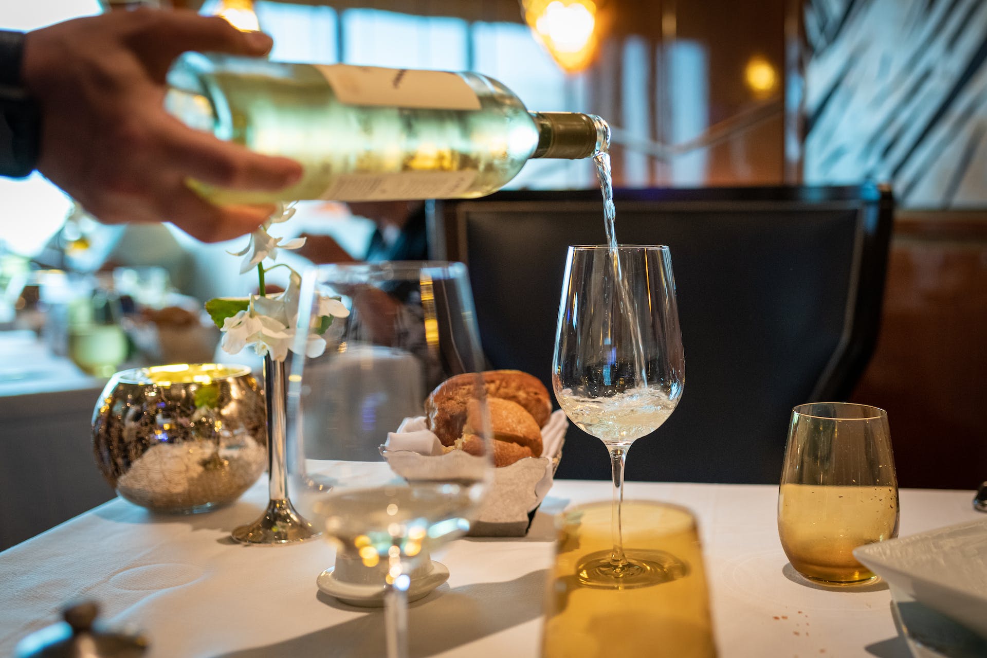 White wine being poured at table