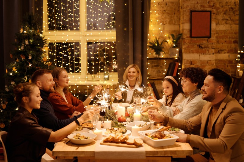 Group of people sharing a holiday meal sitting at the table