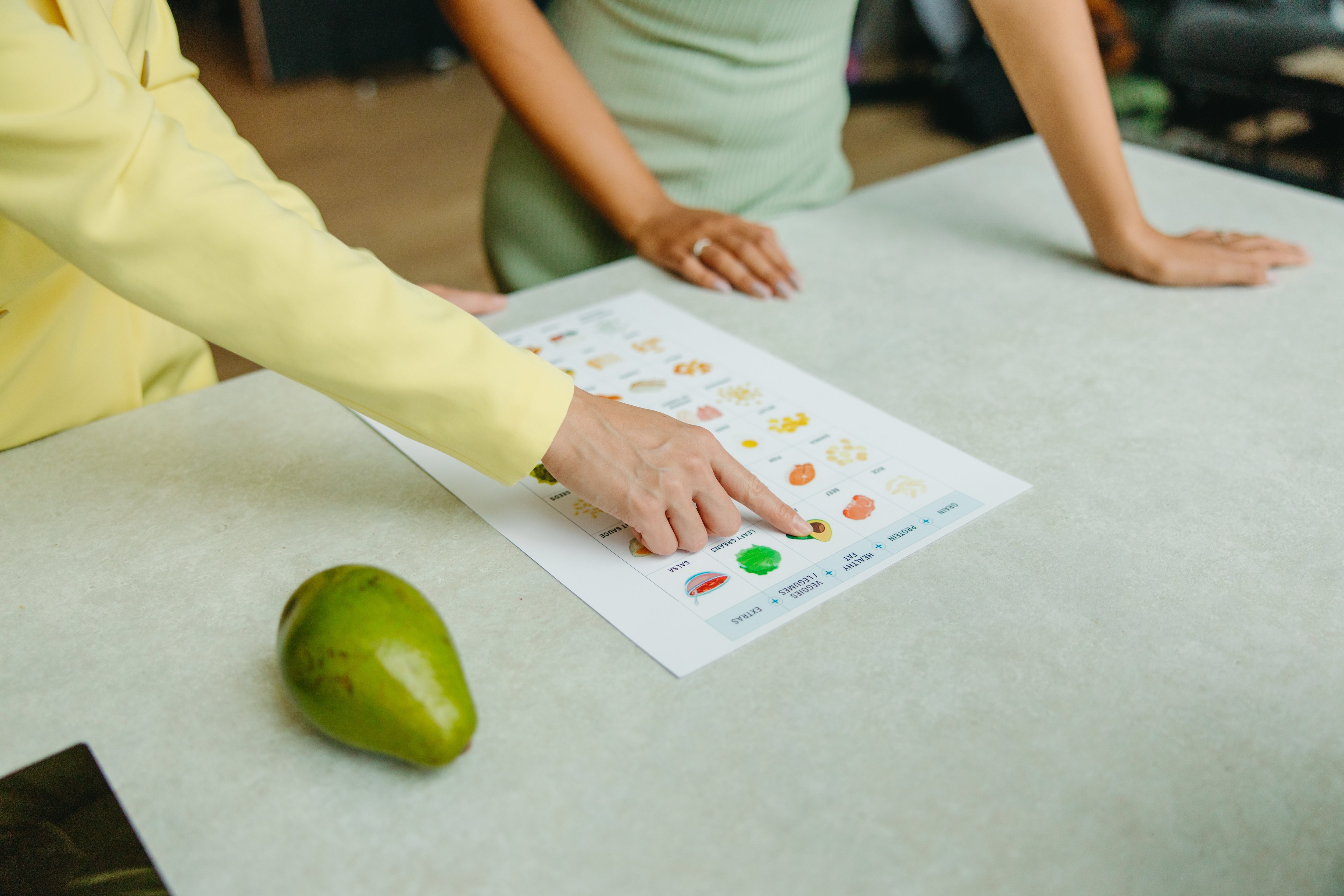 Finger pointing to worksheet with pictures of food