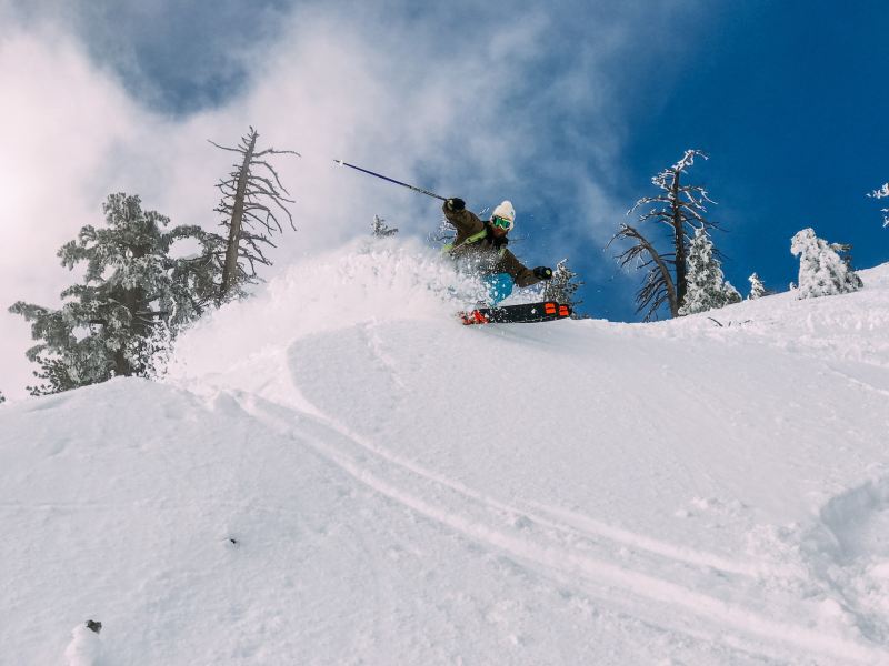 A man skiing in powder.