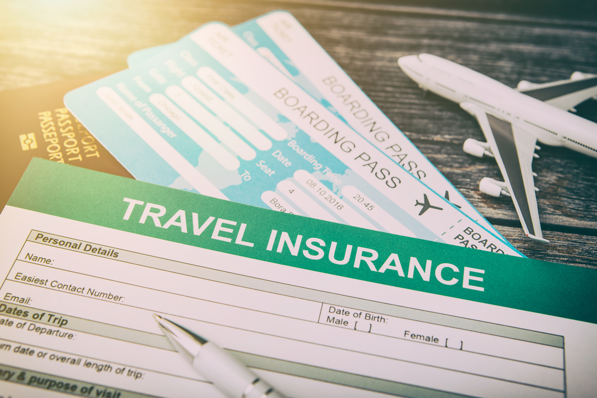 Photo of travel insurance form along with plane tickets.