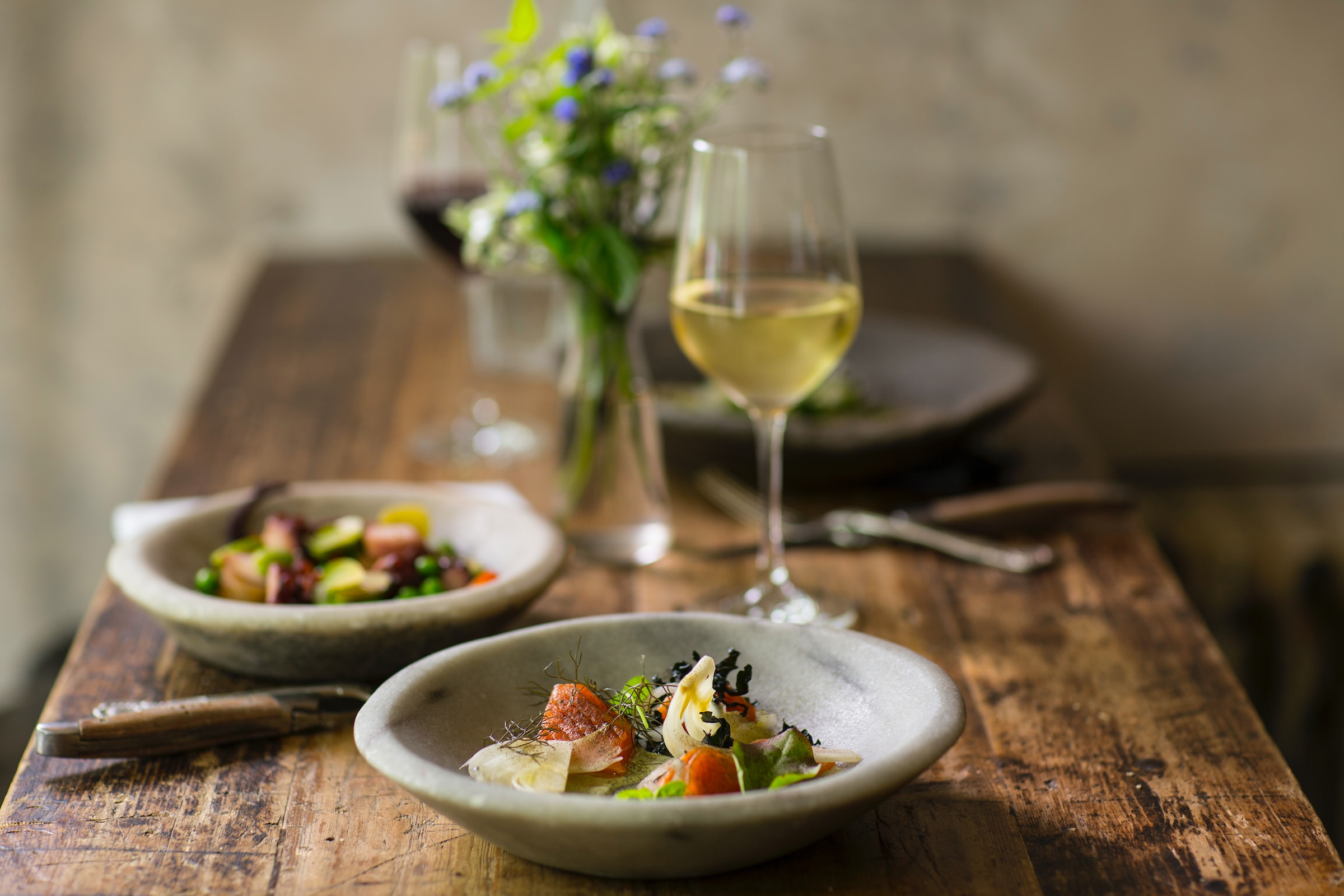 Table set with salads and wine