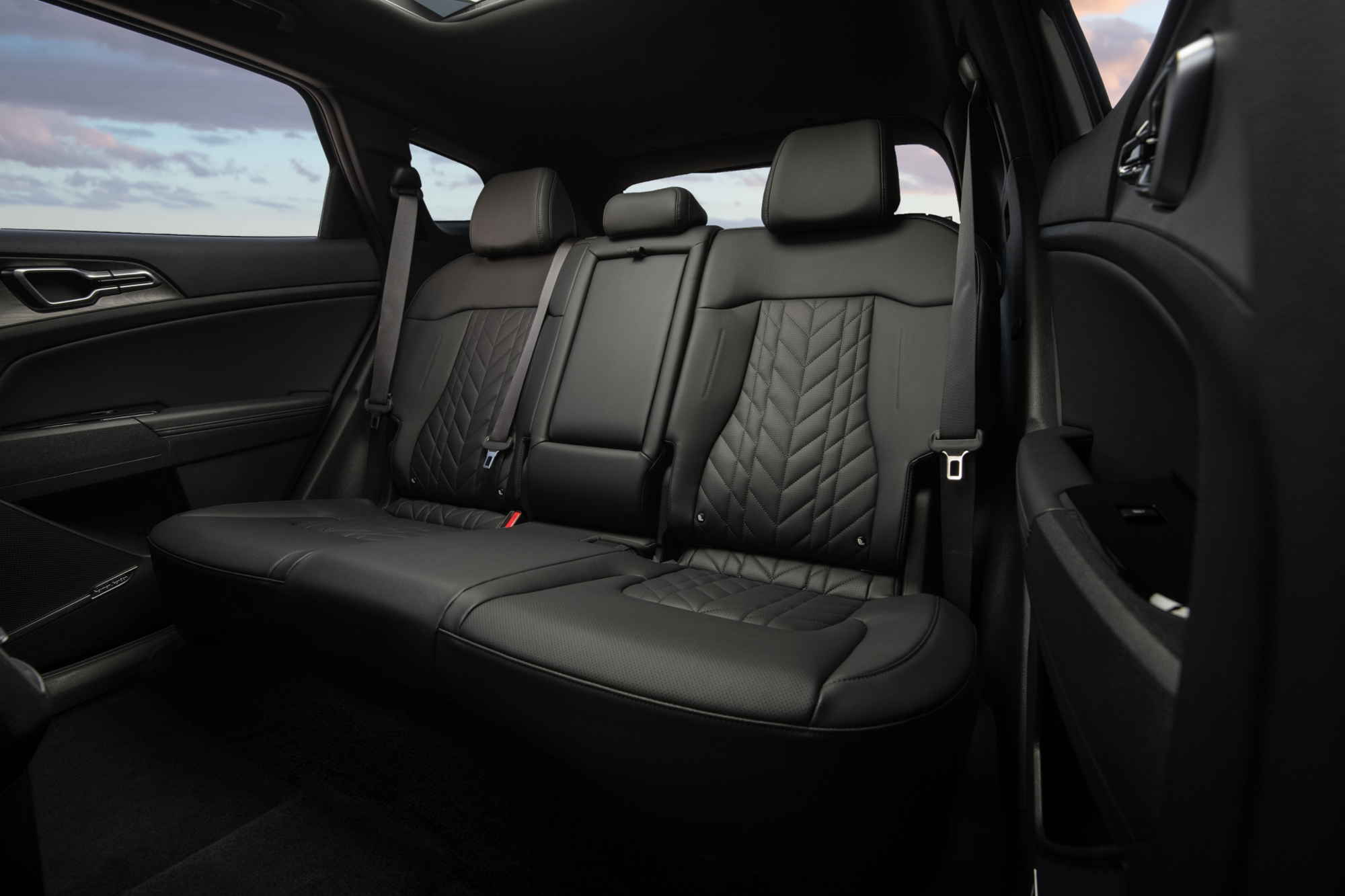 2024 Kia Sportage PHEV back seat viewed from open driver-side rear door.