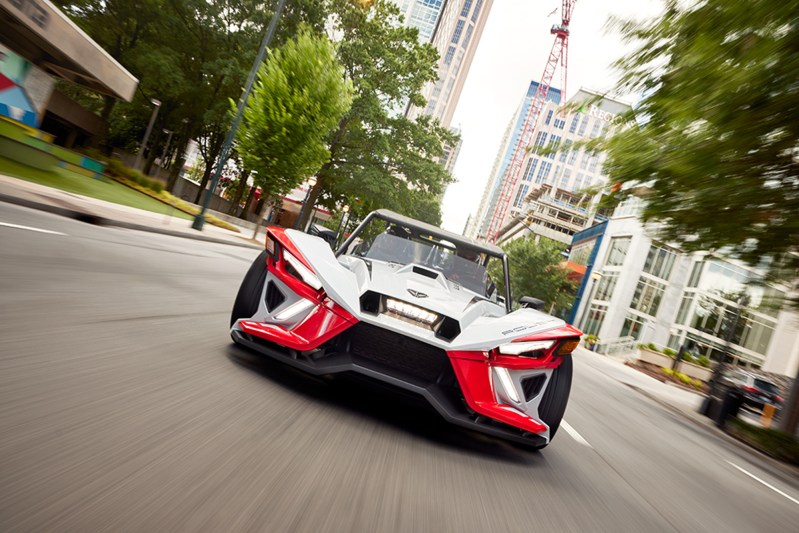 2024 Polaris Slingshot ROUSH Edition on a city street driving straight toward the viewer.