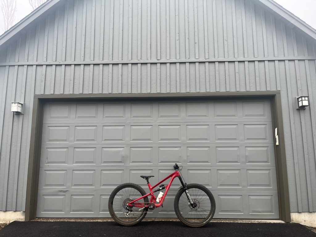 The Revel Rail 29 mountain bike in front of the garage of a house