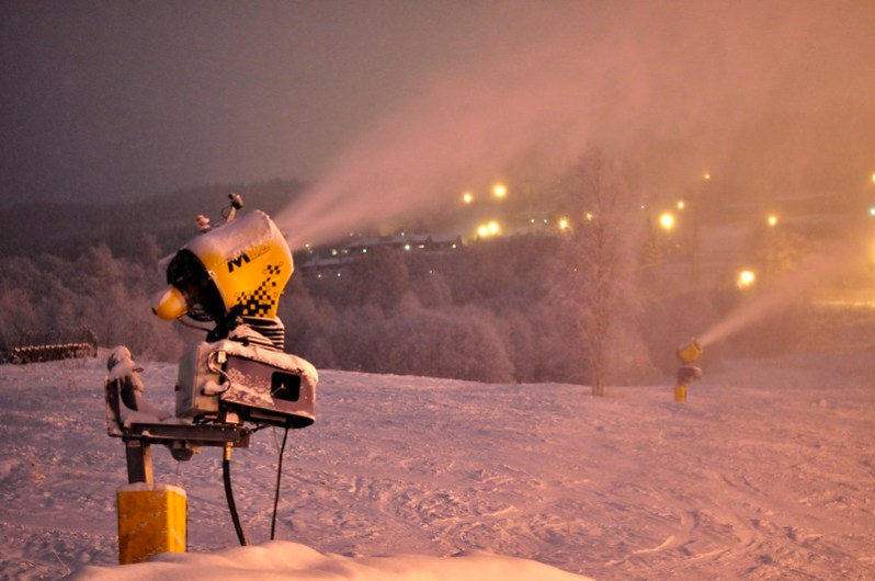 Snowmakers blowing snow at night