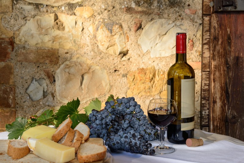 Spread of wine, cheese, and grapes