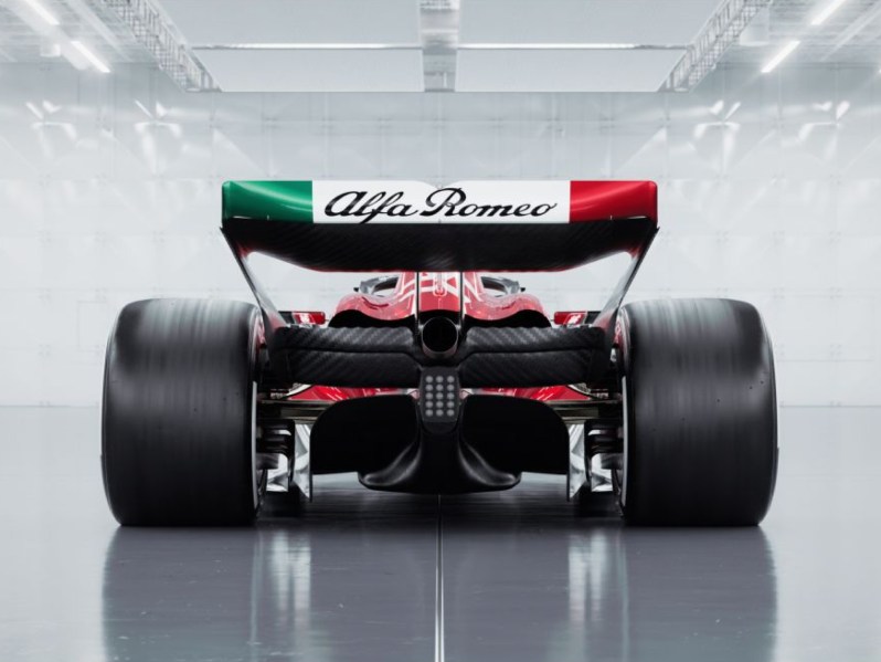 Alfa Romeo final 2023 season Formula 1 race car rear view against a silver background that appears to be an F1 race pit lane garage.
