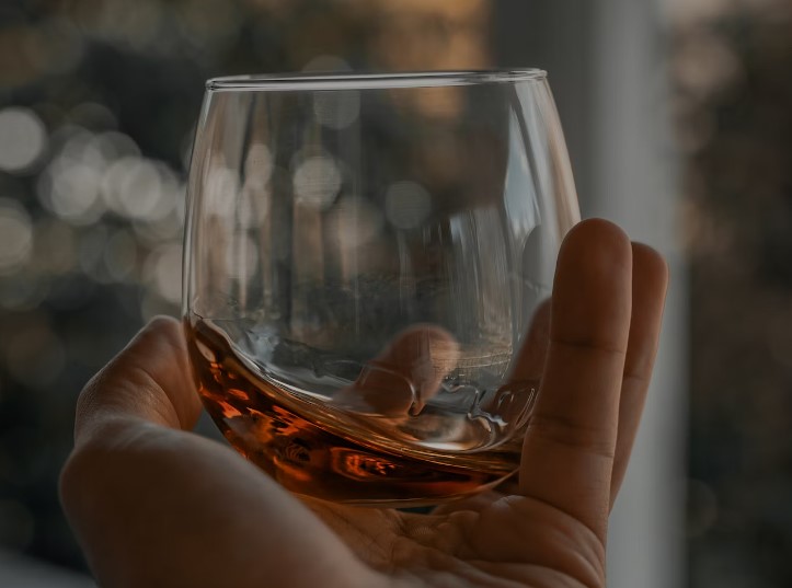 Bourbon in a glass in a hand