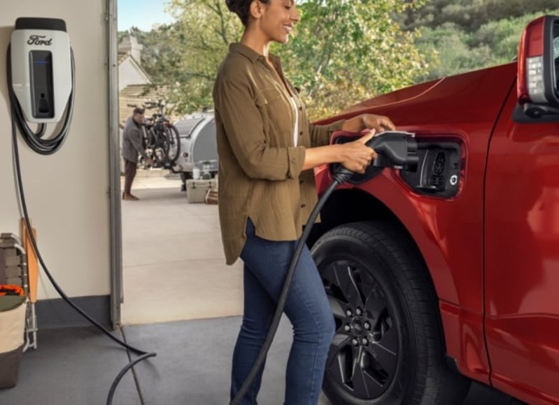 Charging a Ford F-150 Lightning EV with a Level 2 wall charger in a garage.