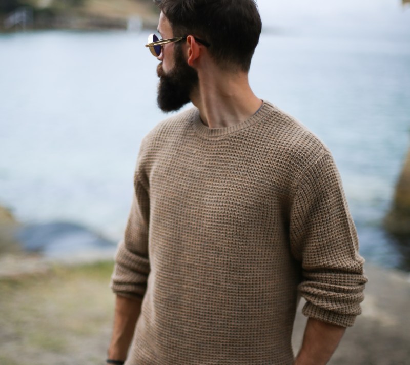 Man in sweater on the beach