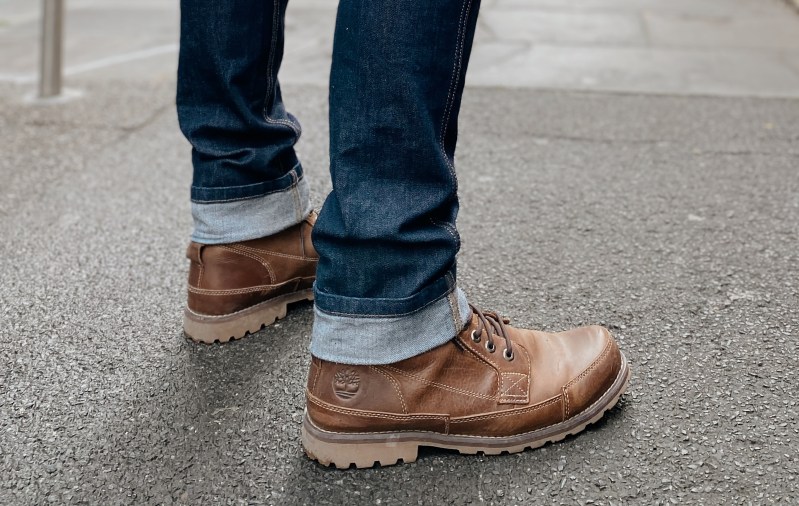 Man wearing boots on pavement