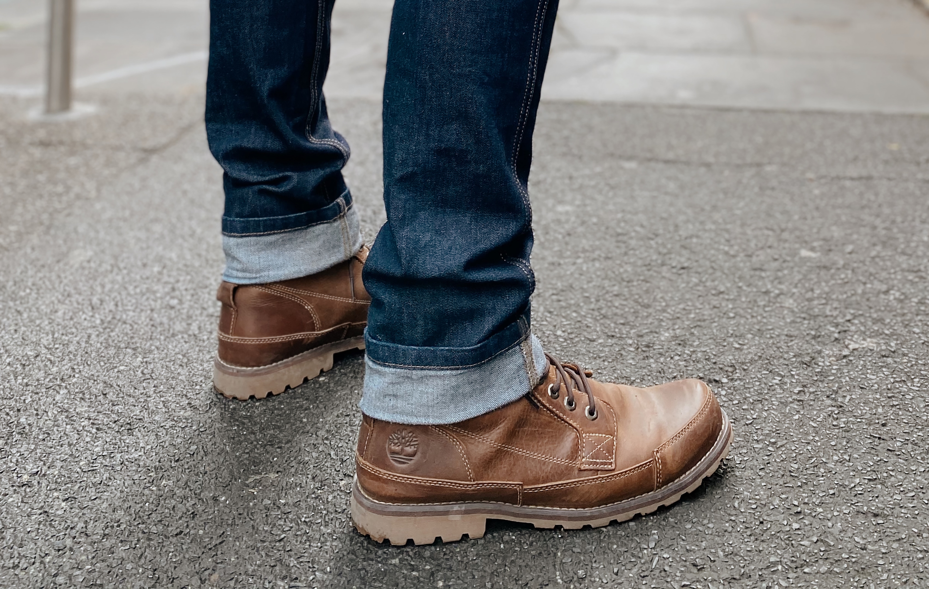 Man wearing boots on pavement