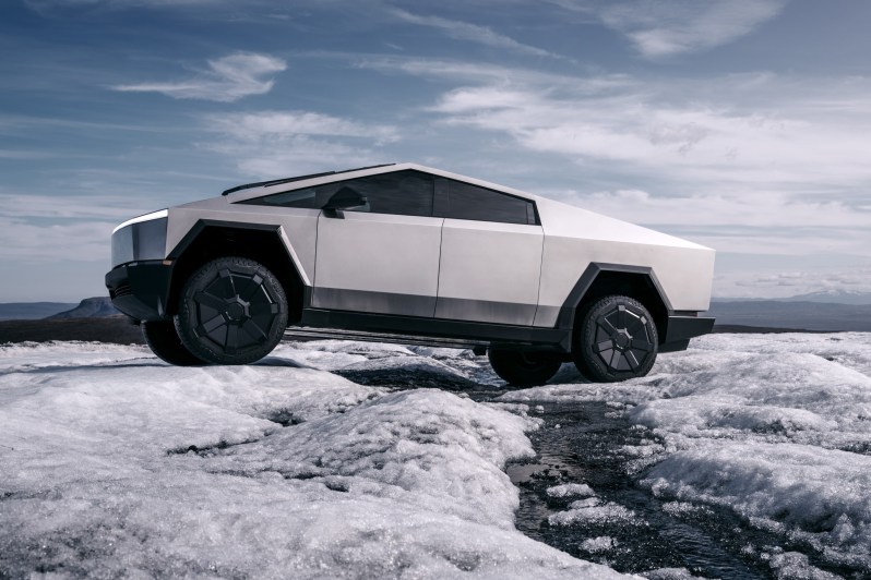 Tesla Cybertruck EV driving in snow.