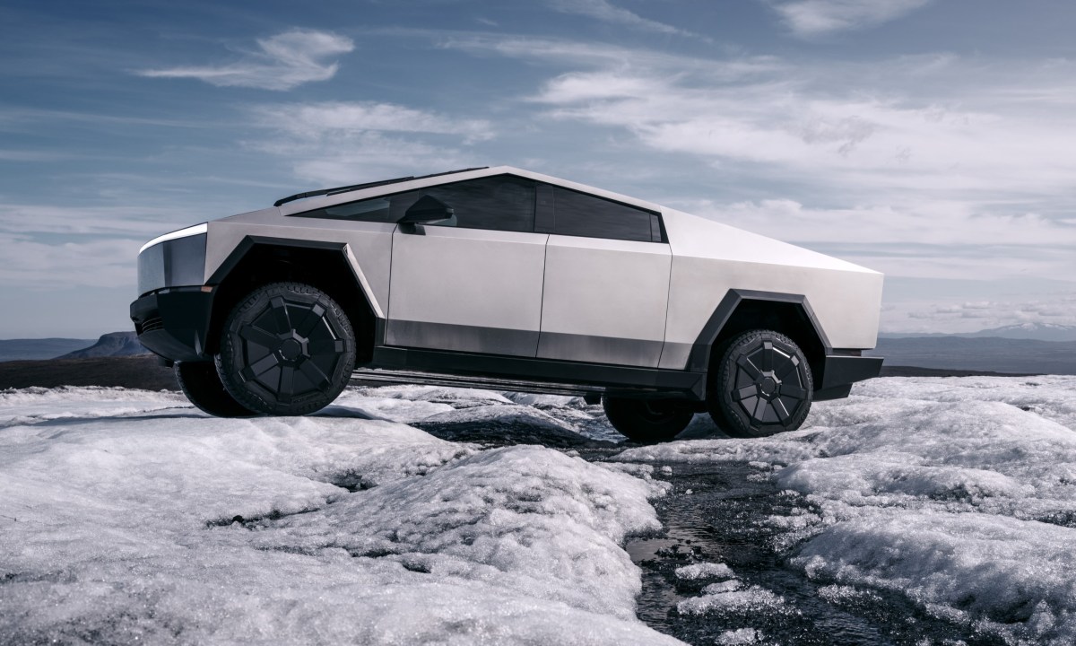 Tesla Cybertruck EV driving in snow.