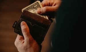 man holding wallet with money