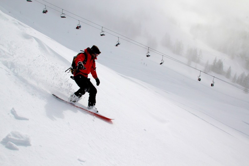 snowboarder freeriding in red jacket