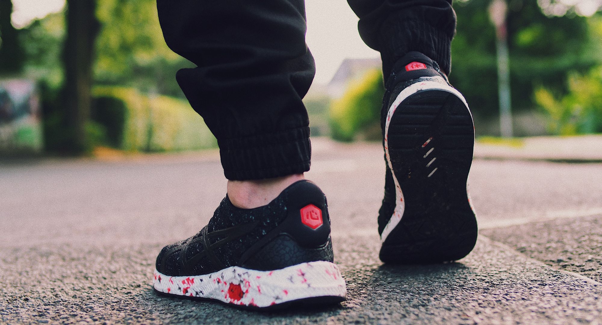 Person in black sneakers walking on the street