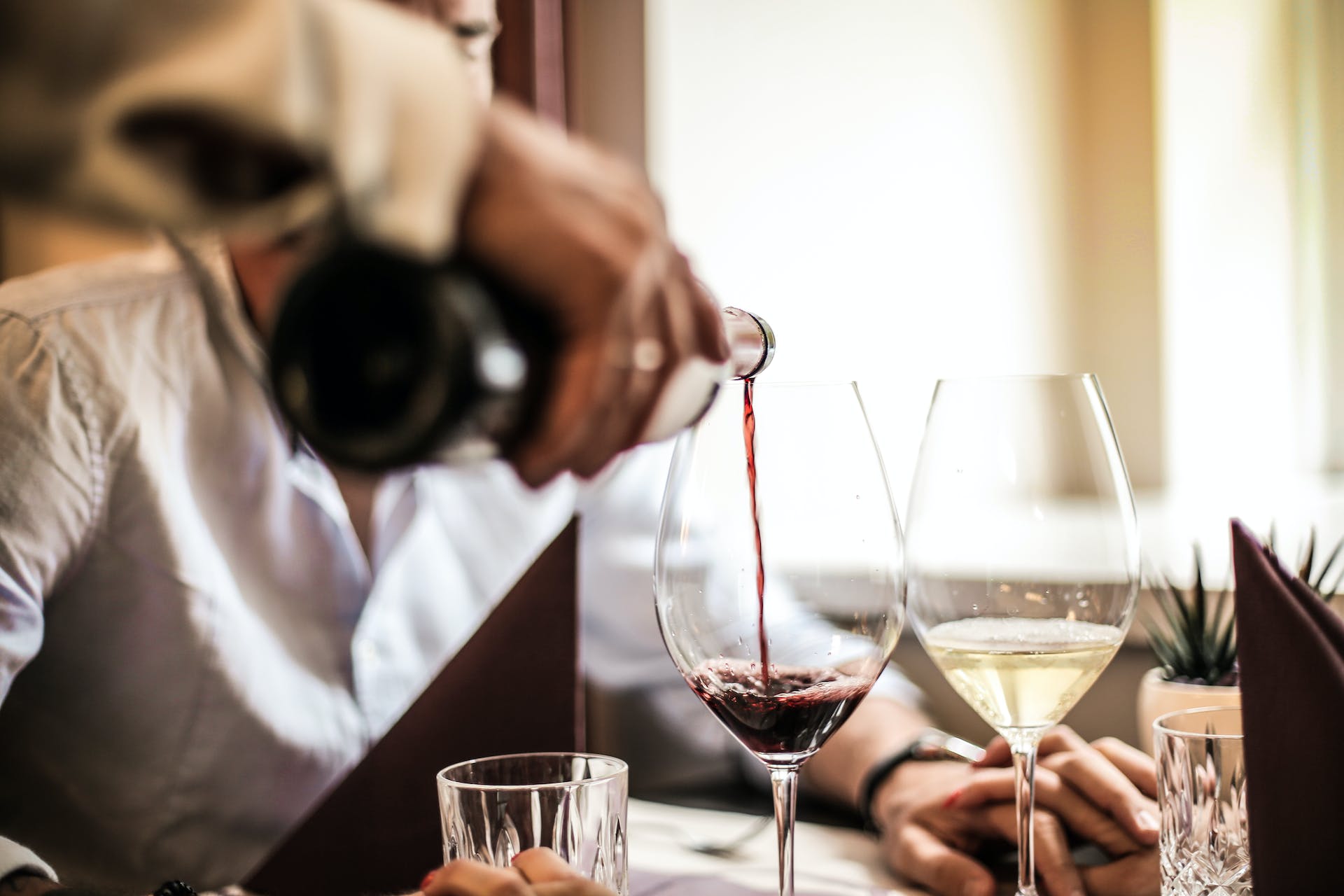 Wine being poured at dinner table