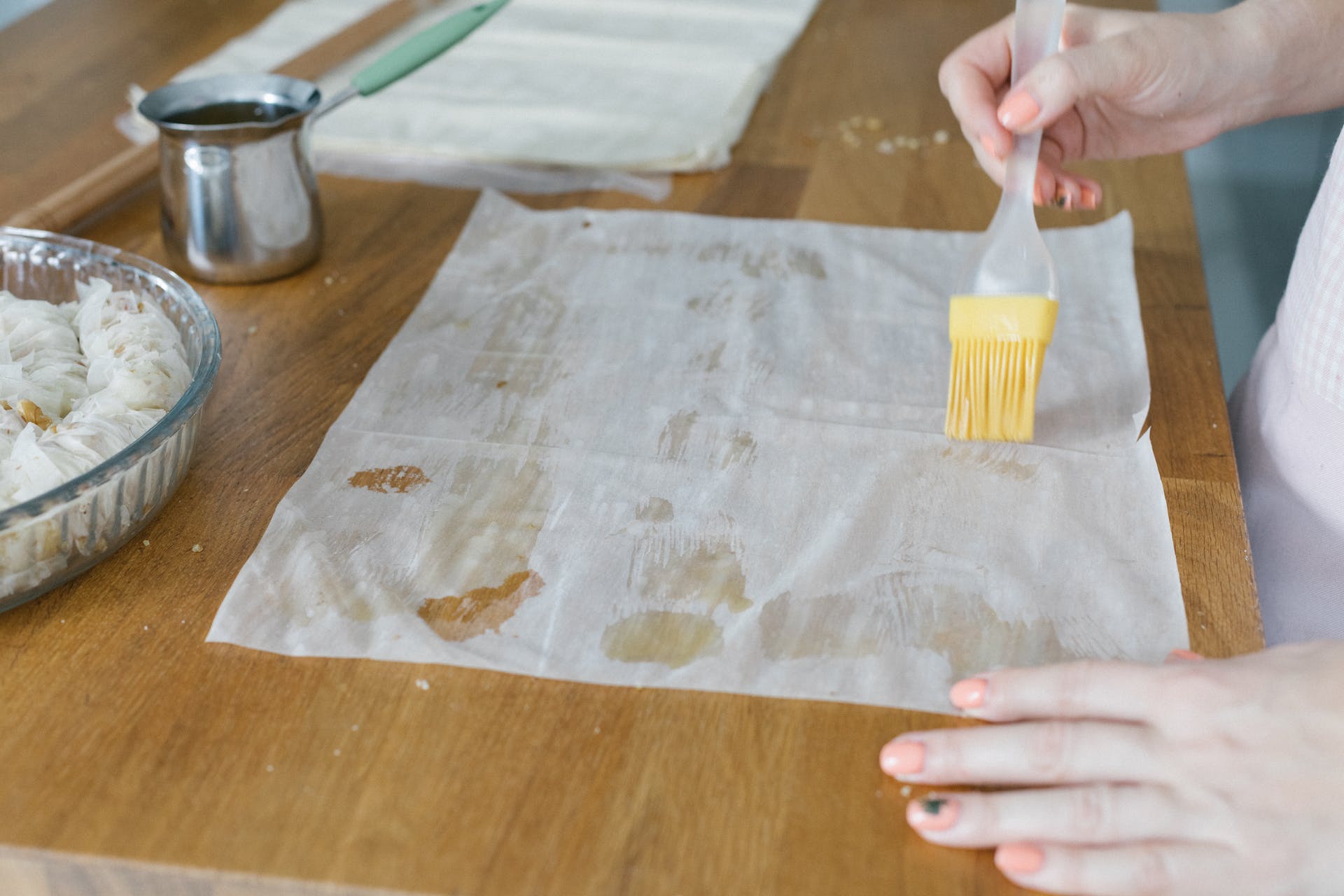 Phyllo dough being brushed with butter