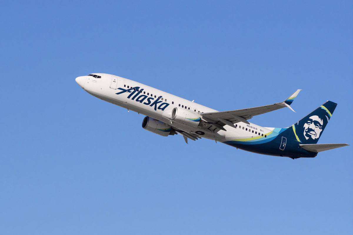 Alaska Airlines plane flying in sky