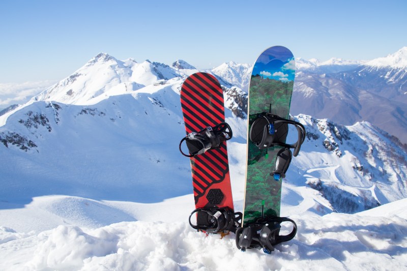 Two snowboard standing in the snow against the backdrop of the beautiful snow-capped mountains