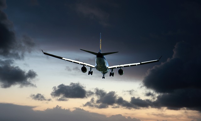 Plane flying at sunset