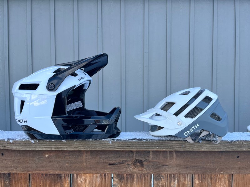 A full-face and a half-shell mountain bike helmet