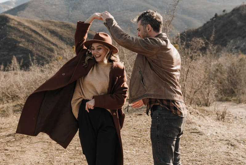 Man dancing with a woman in suede jacket