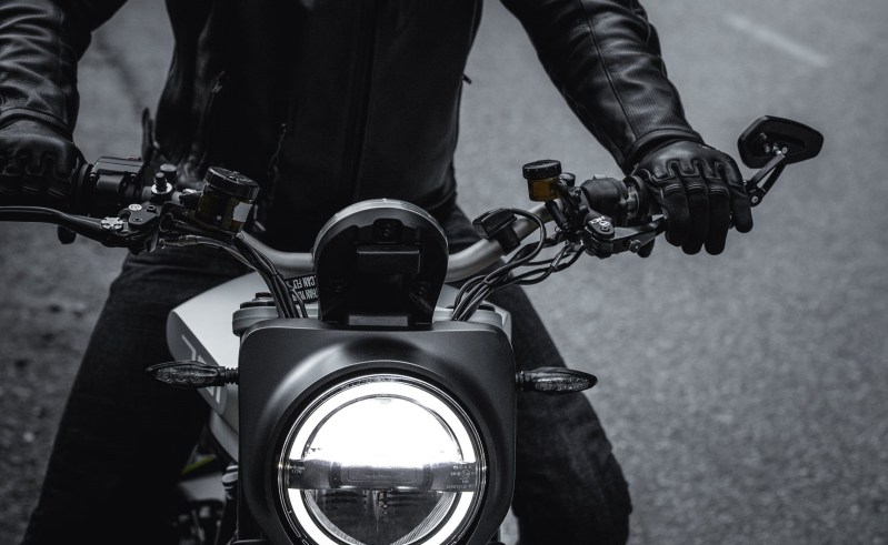 Man on a motorcycle with gloves and jacket