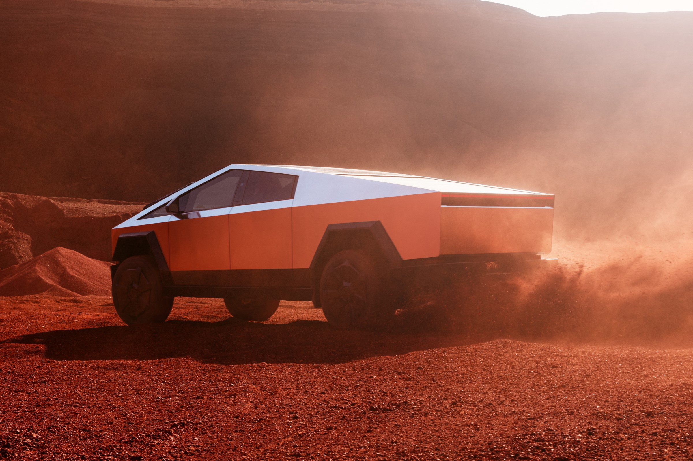 Tesla Cybertruck driving in the desert.