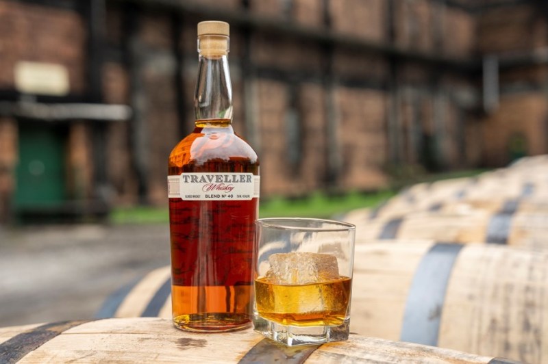 Traveller Whiskey with a glass of it next to the bottle