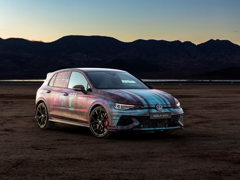 VW GTI concept on flat earth with mountains in the background, right side three-quarter front view.