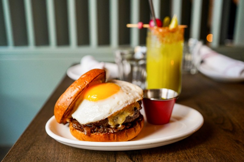 brunch burger with egg on plate.