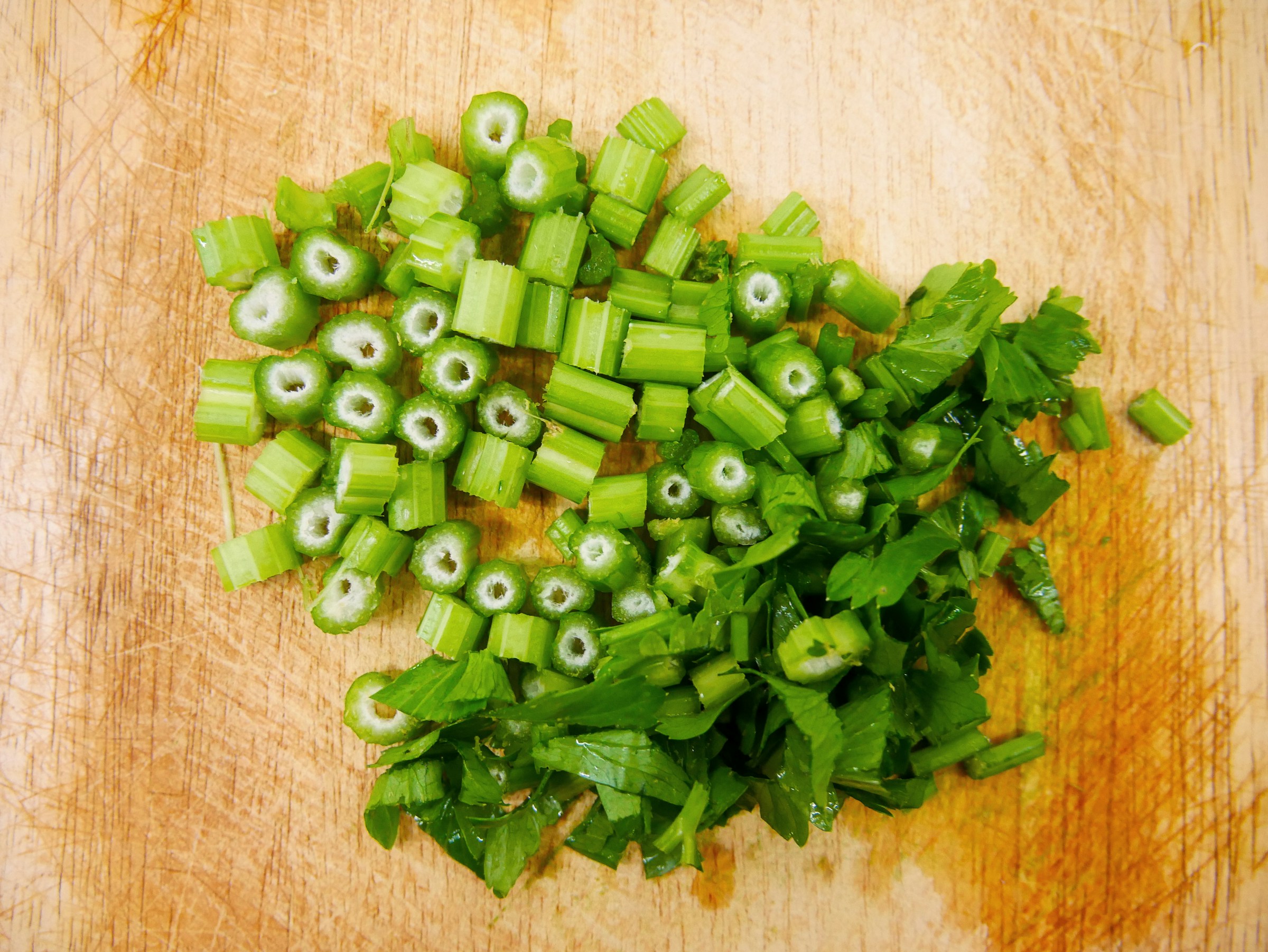finely chopped green celery on a wooden background