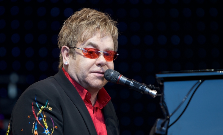 Elton John singing with red glasses
