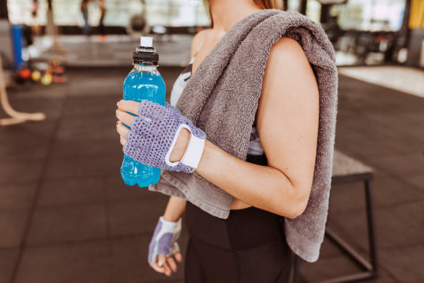 Woman holding a sports drink.