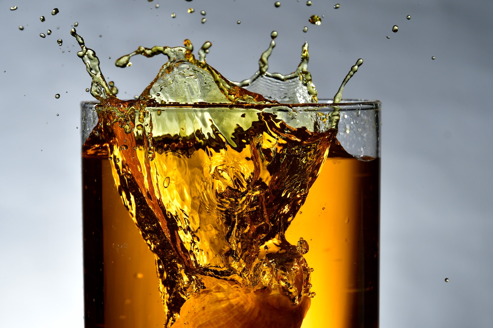 Whiskey splashing from a glass