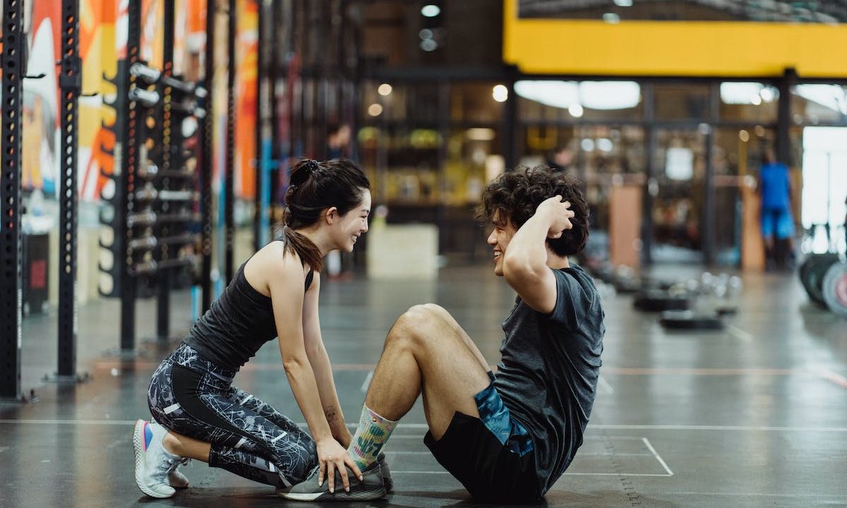 Man doing situps with help