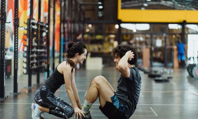 Man doing situps with help