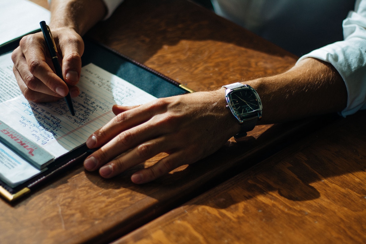 a man journaling on lined paper