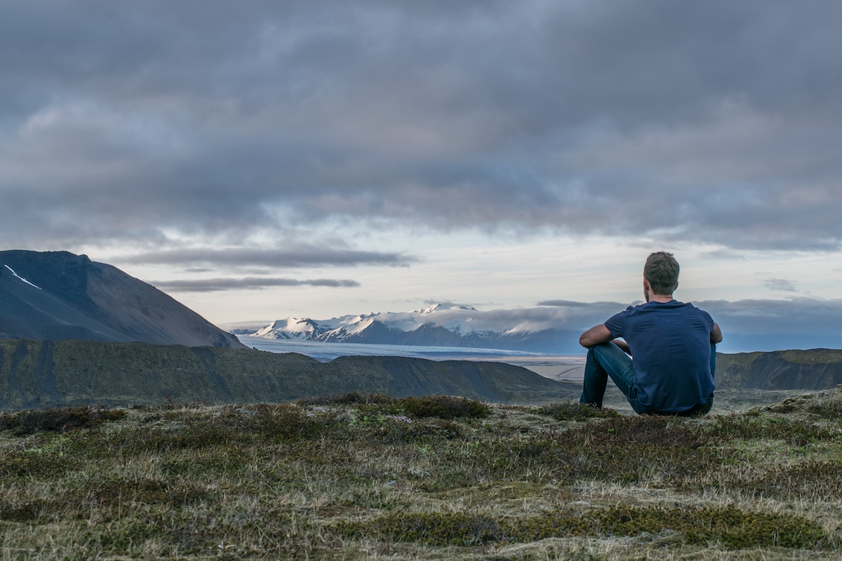 a man staring out at mountains