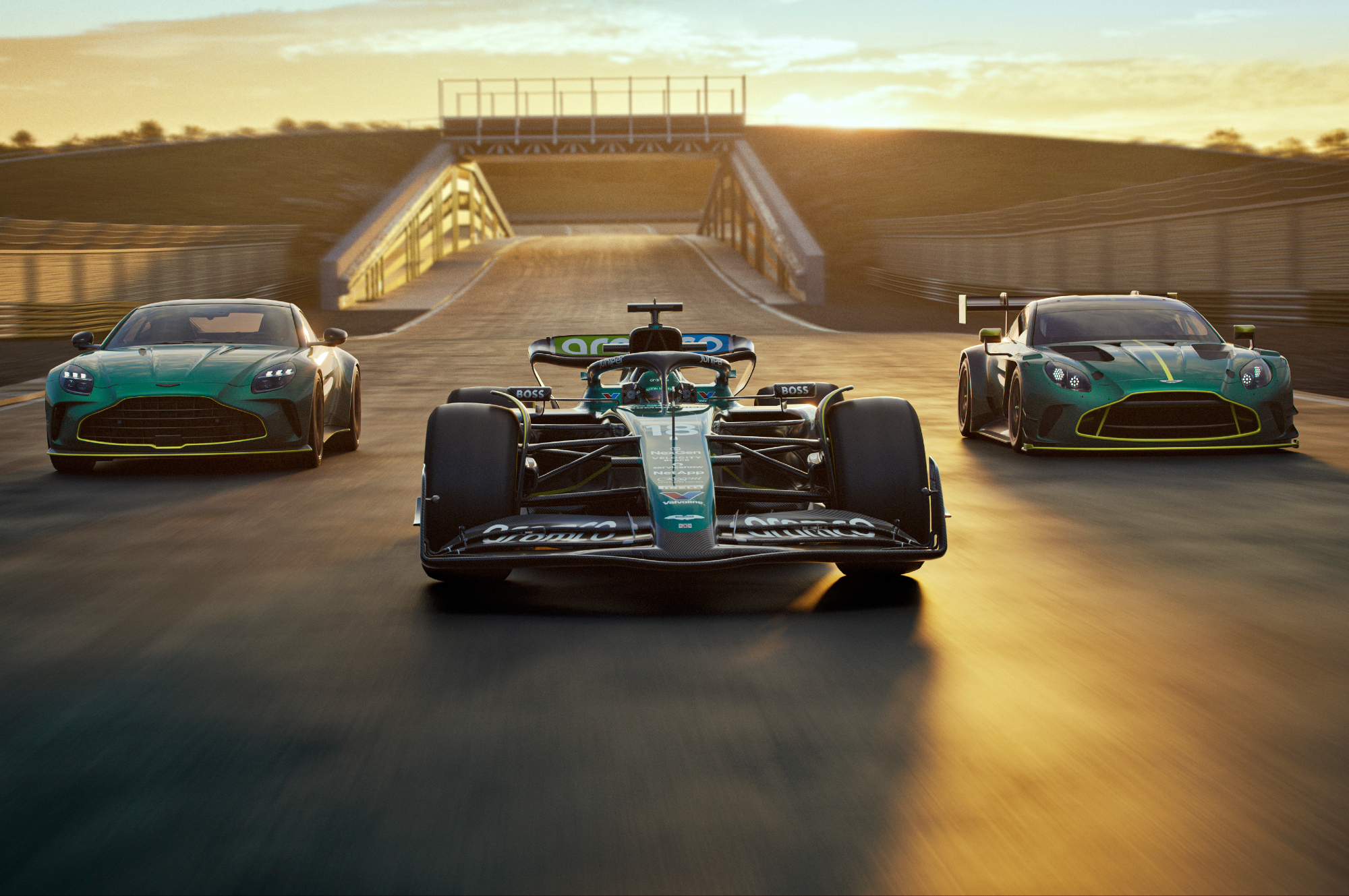 Aston Martin Vantage sports car, Aston Martin AMR24 Formula 1race care and Aston Martin Vantage GT3 racer lined up across a racetrack.